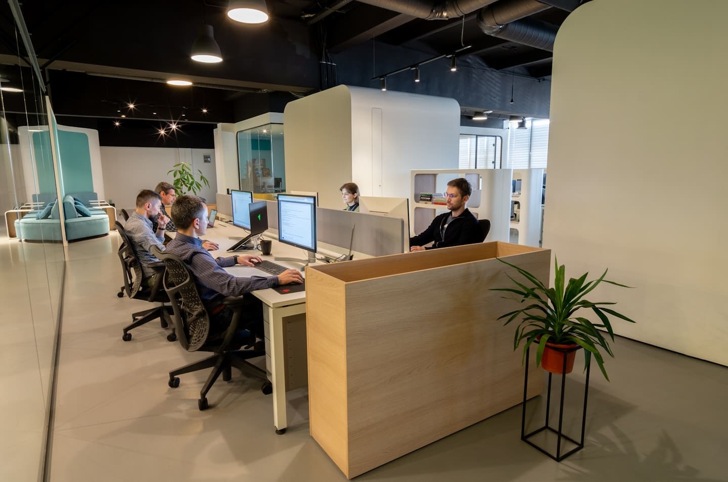 Professionals working diligently at computers in a modern office.