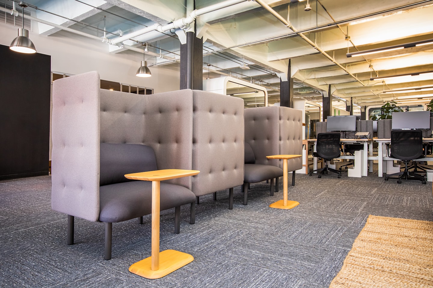 Modern open-plan office with collaborative seating pods.